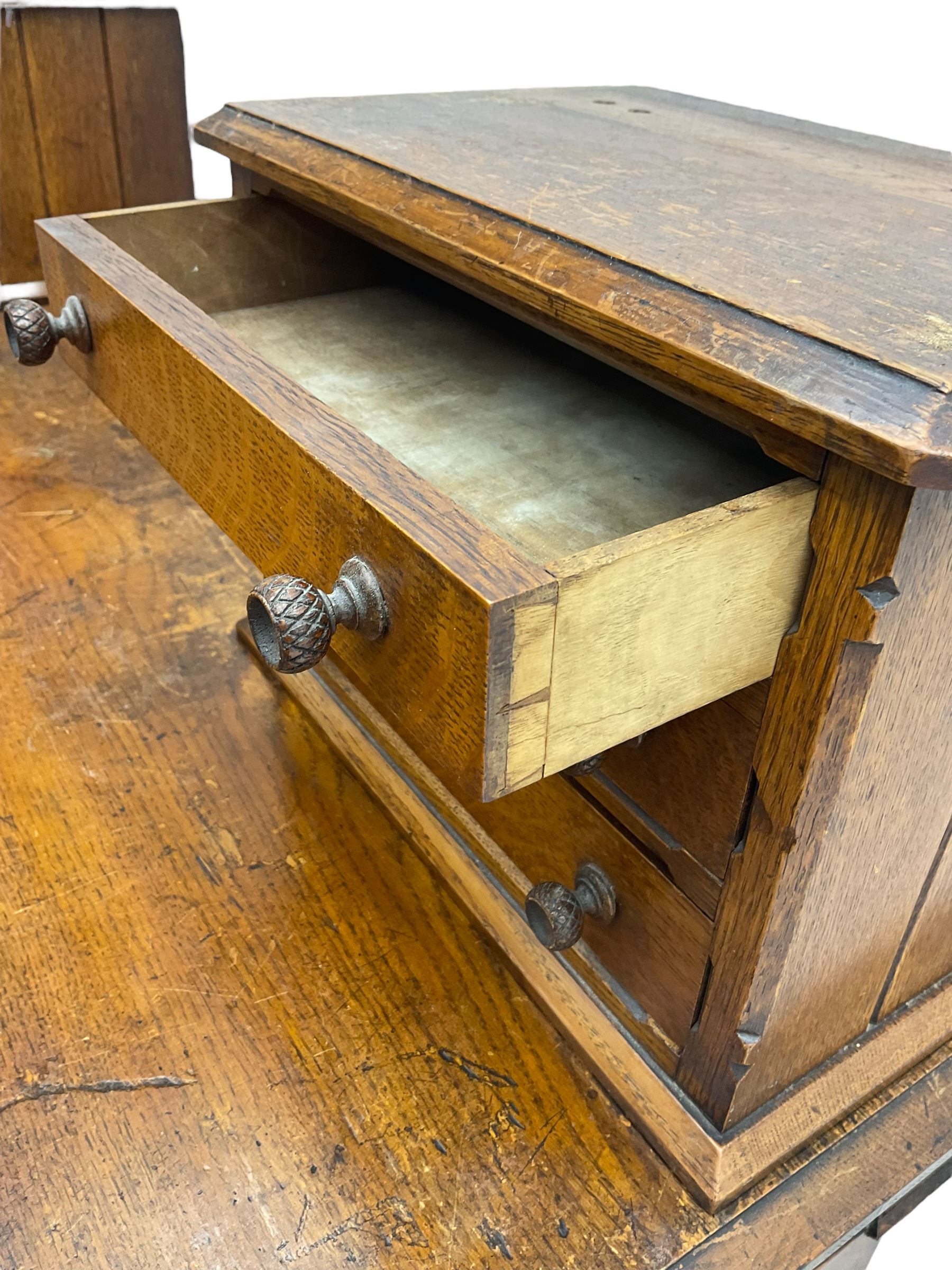 Late 19th century heavily carved oak twin pedestal desk, rectangular top with two raised trinket or correspondence structures each with three drawers, rectangular top over three frieze drawers carved with acorn and oak leaf decoration, each pedestal with three drawers with acorn husk shaped handles