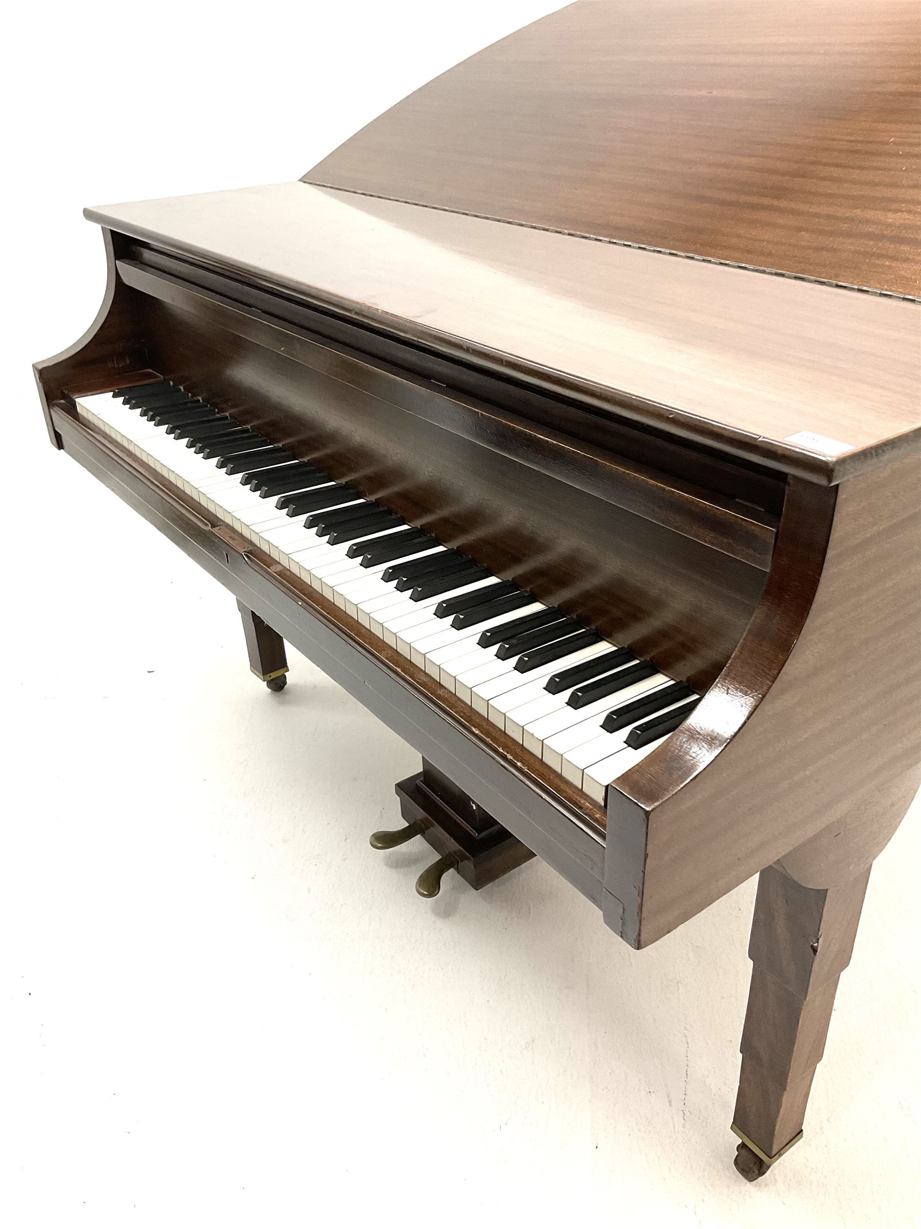 Early 20th century mahogany cased Strohmenger London baby grand piano, demi lune shape, over strung cast iron framed, raised on square tapered supports and castors 