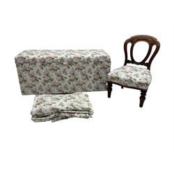 Ottoman blanket box upholstered in floral pattern fabric, matching bedroom chair and curtains