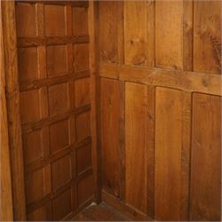 Mouseman - early-to-mid-20th century figured panelled and adzed double wardrobe of large proportions, the arcade carved cresting rail over two doors with adzed and figured oak panels, with wrought metal hinges and latch, relief carved mouse signature, the interior fitted with hanging rail, by the workshop of Robert Thompson, Kilburn