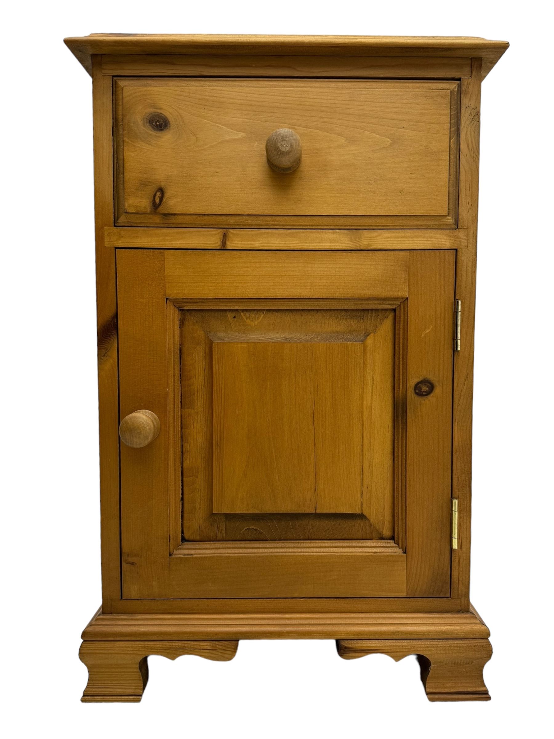 Pine chest of drawers topped with carved pediment with acorn and oak leaf motif, fitted with two short over three long drawers, standing on shaped apron base (W92, D46, H97cm); pine bedside cabinet, single drawer above paneled cupboard door enclosing open storage, shaped plinth base (W43, L32, H67cm)