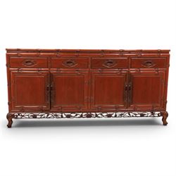 20th century Chinese ornately hardwood sideboard, rectangular top over four drawers above four cupboards, pierced carved apron, raised on cabriole legs 