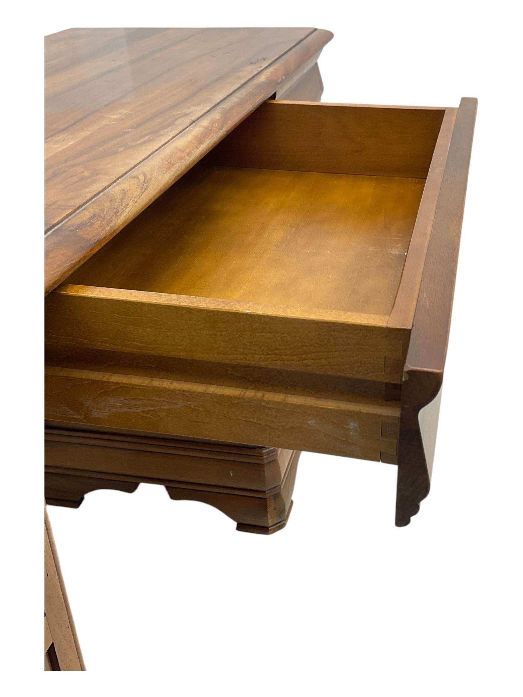 French cherry wood kneehole desk or dressing table, moulded rectangular top over twin pedestal bases each housing three drawers with brass-effect swing handles, resting on bracket feet