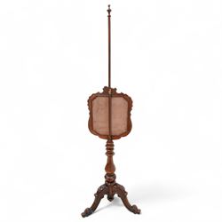 Victorian rosewood pole screen, shaped and shell carved frame enclosed needlework panel, on turned pedestal with three floral carved splayed supports with scrolled foliate terminals 