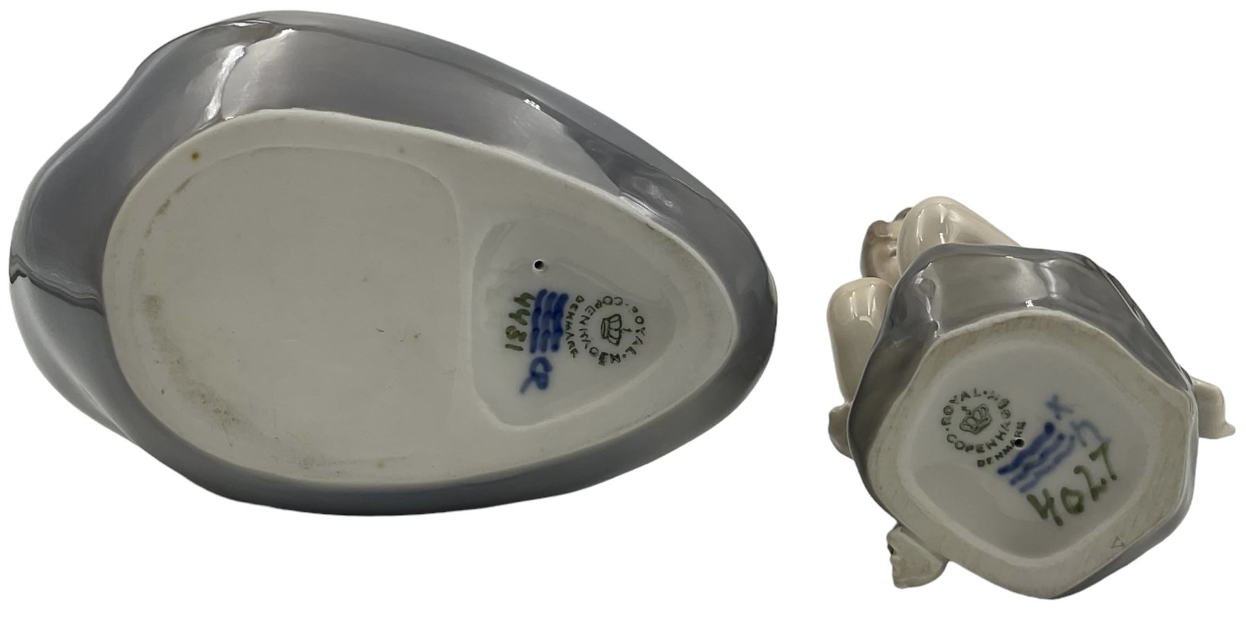 Two Royal Copenhagen figures, comprising The Little Mermaid, modelled by Edvard Eriksen, no. 4431 and Royal Copenhagen girl on stone no 4027, Little Mermaid H22cm