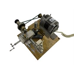 Lorch 6mm watchmakers lathe with tailstock, crosslide, tool rest, four-way tool post, pulleys and motor. Mounted on a wooden board.