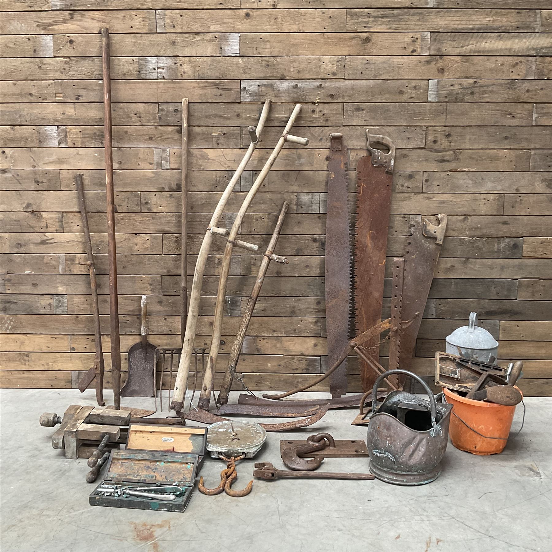 Large quantity of vintage hand tools including scales, scythes, saws etc