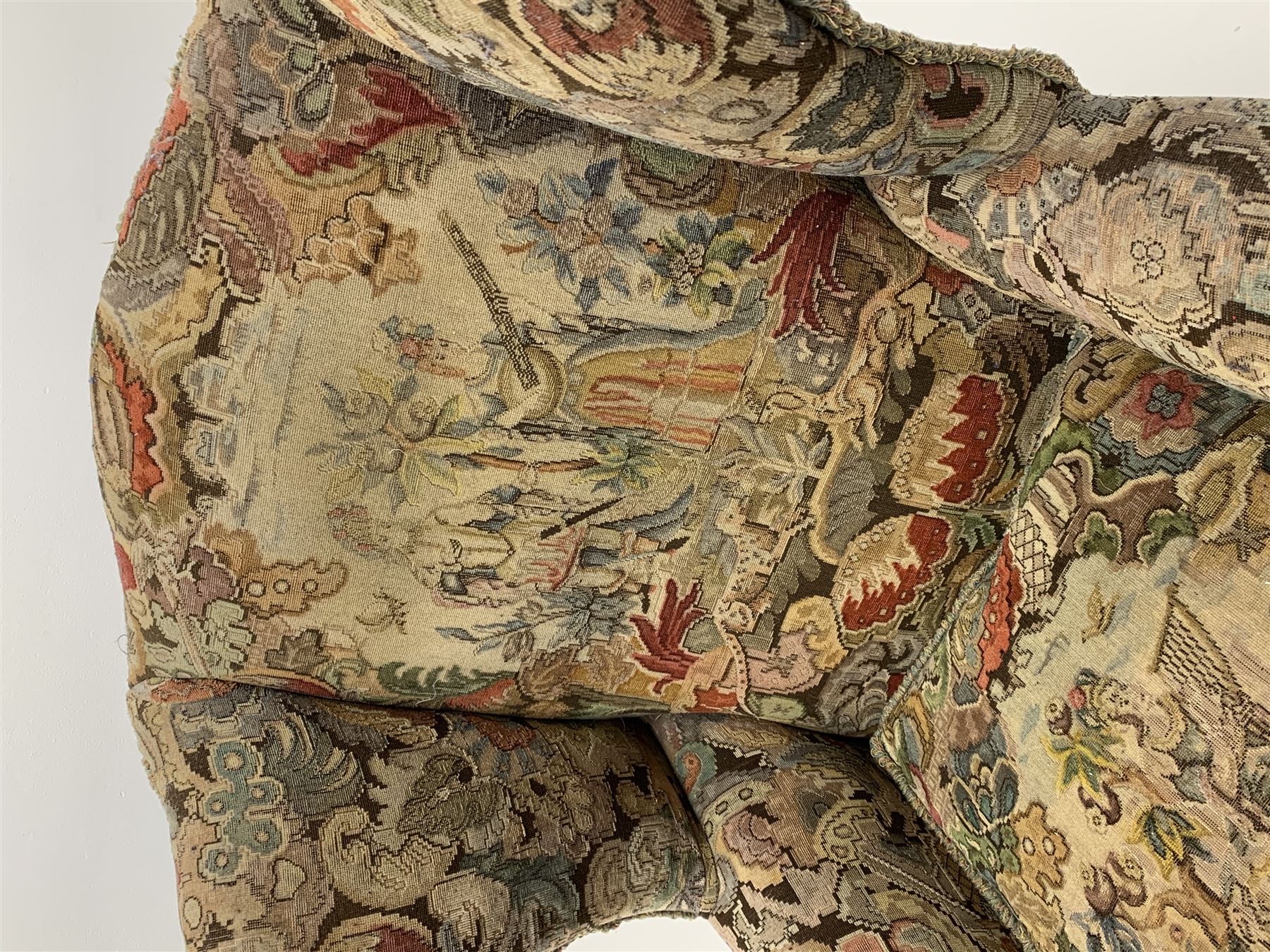 Matched pair early 20th century Queen Anne style wingback armchairs, walnut framed, sprung seats with seat cushions upholstered in needle work cover, shell carved cabriole front feet