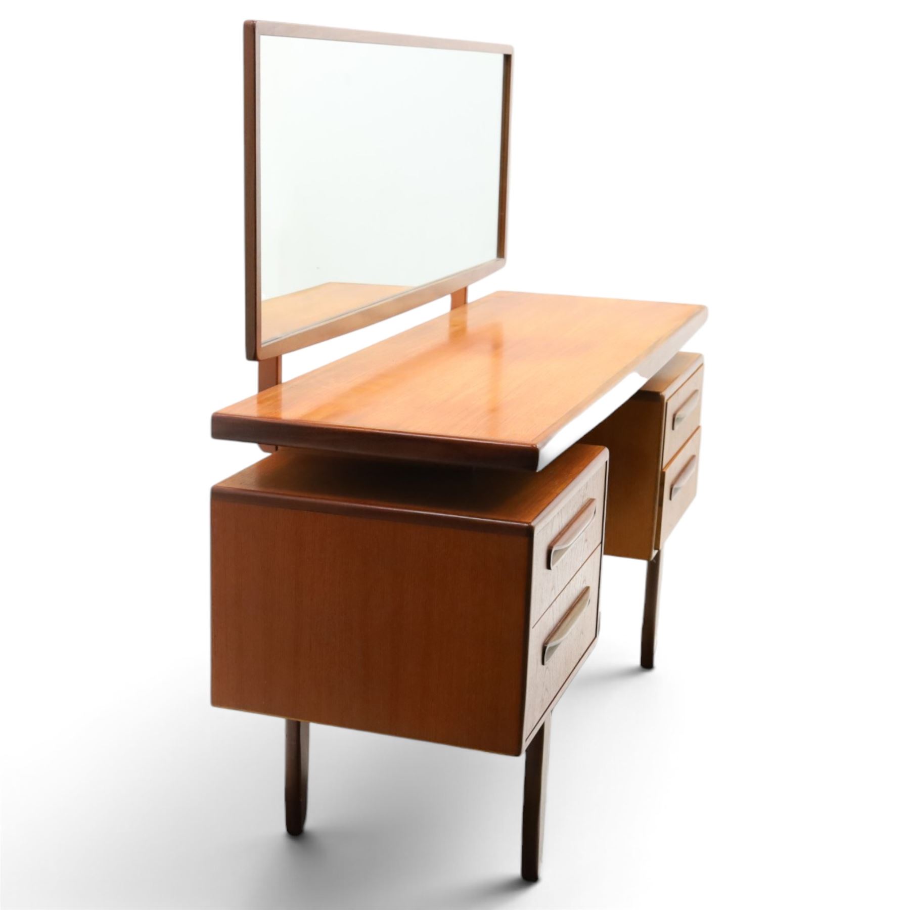 G-Plan - ‘Fresco’ teak dressing table, rectangular top with raised rectangular mirror, fitted with four drawers arranged as twin pedestals with sculpted handles, central knee-hole, on tapering supports