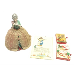 Continental porcelain half-doll shade or cover, the lace covered crinoline dress with open wire-work frame H30cm; Valentine Valette Washable Series Mabel Lucie Attwell bathroom wall plaque; and two mid-20th century musical greeting cards with hand cranked action (4)