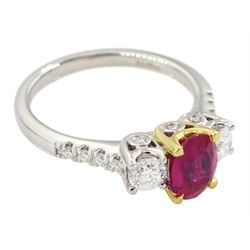 18ct white gold three stone oval ruby and round brilliant cut diamond ring, with diamond set shoulders and gallery, stamped 750, ruby 0.89 carat, total diamond weight approx 0.55 carat