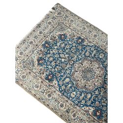 Persian Nain blue and ivory ground rug, wool with silk inlay, overall arabesque design, central medallion surrounded by interlacing and scrolled leafy branches and palmettes, the scrolling border decorated with stylised plant motifs, within guard stripes