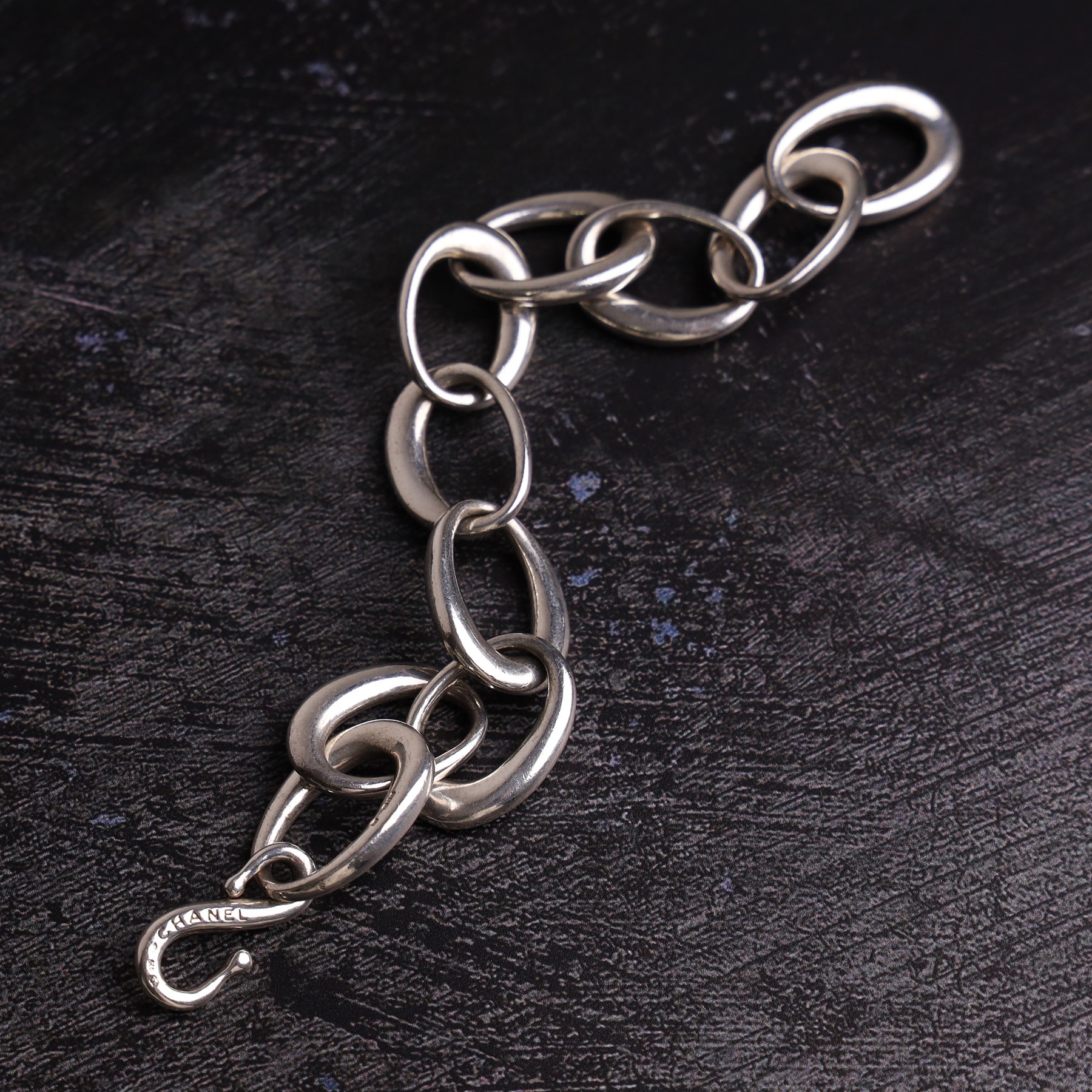 Chanel silver bracelet, with ten oval interlocking links and a hook clasp, London 2000
