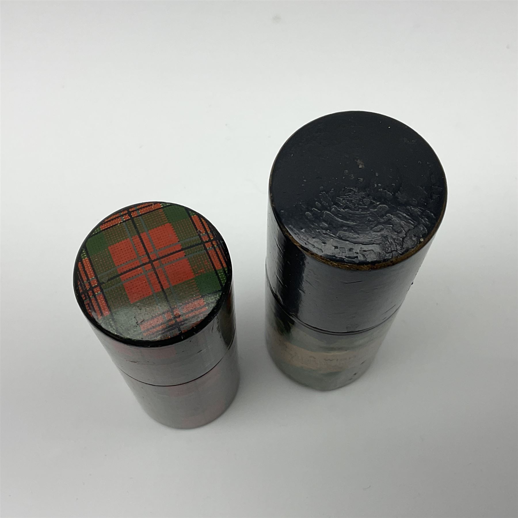 Mauchline ware black lacquered octagonal bobbin box, the hinged cover with forget-me-not floral decoration and sentimental verse, opening to reveal six bobbin holders and retail label for Clark & Co, together with a Mauchline ware sewing box, with floral decoration throughout and verse to hinged cover, a similar black lacquered needle holder and a Mauchline Tartan ware needle holder, largest diameter D11.5cm