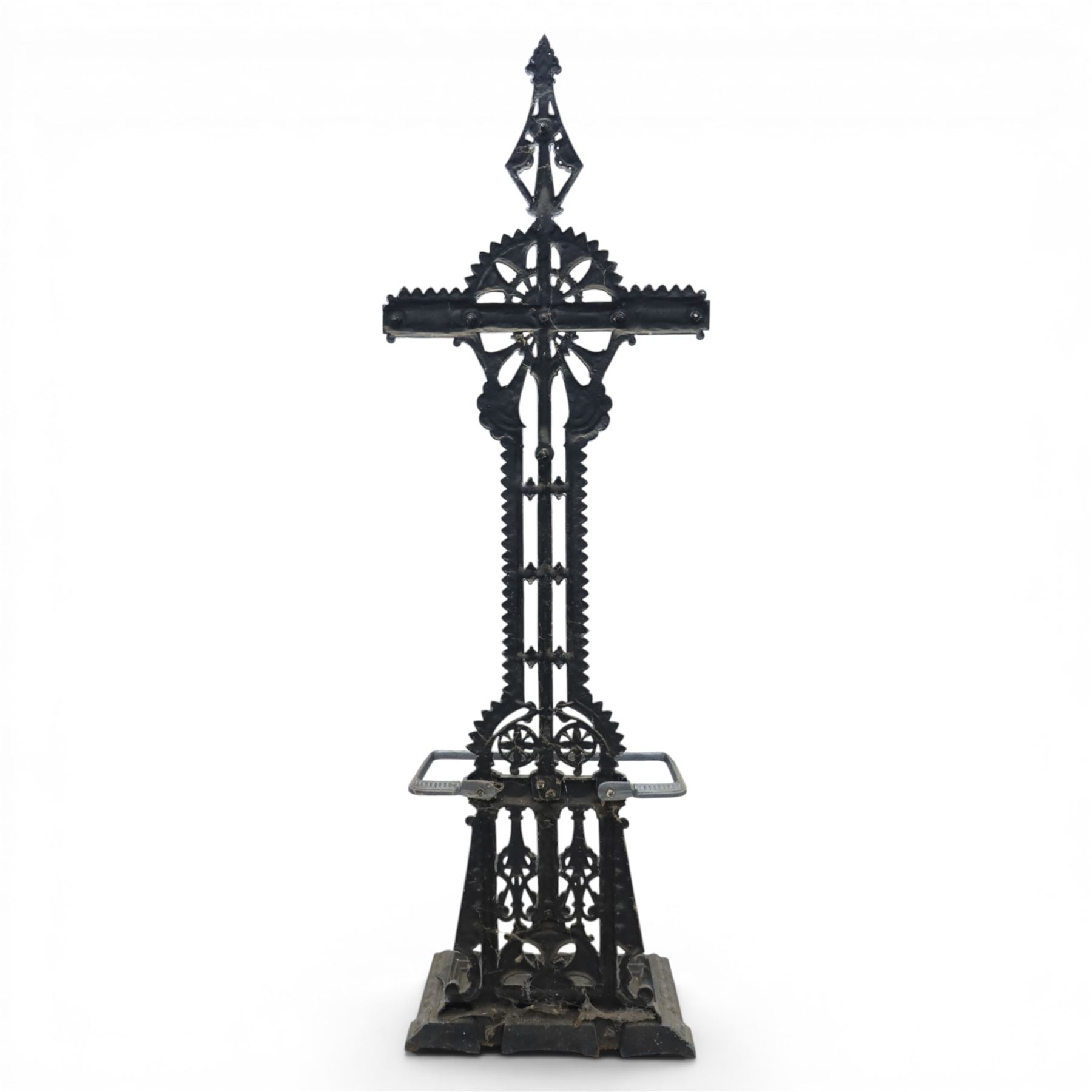 Late 19th century cast iron hall stand in the style of Christopher Dresser, cross shaped upper section with radiating wheel motif and applied hooks, architectural upright with pierced Gothic and geometric detail, fitted with rectangular drip tray and pierced surround, raised on stepped plinth base with bead decoration