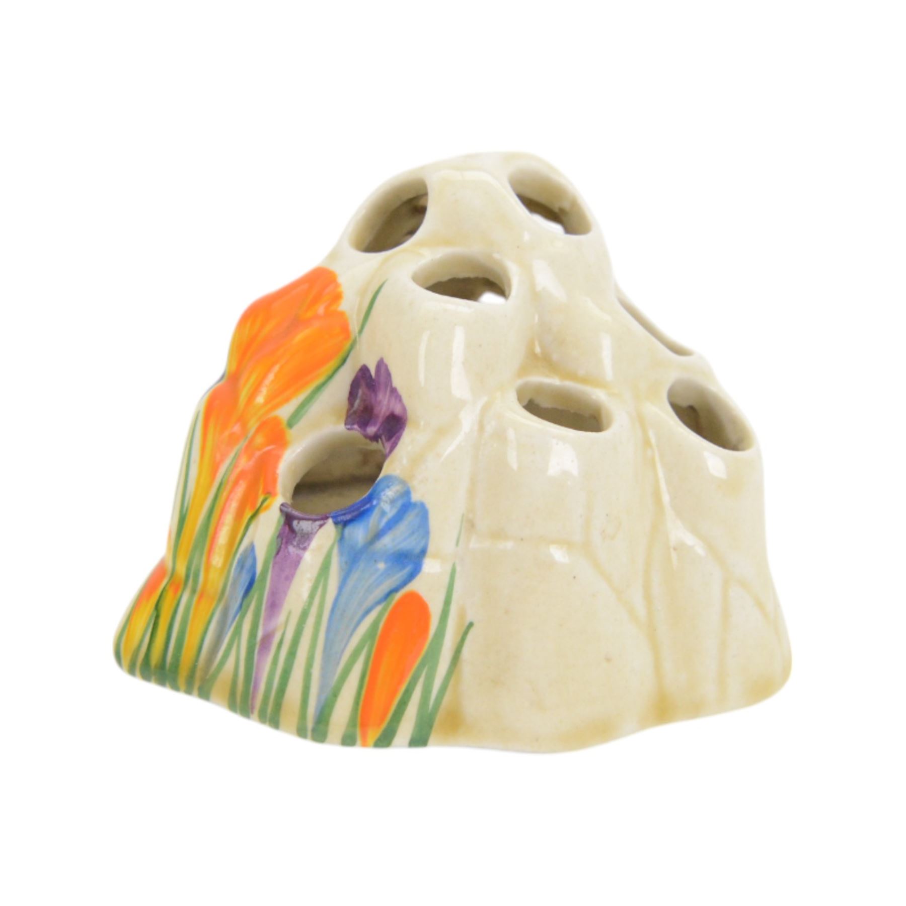 Royal Staffordshire Crocus by Clarice Cliff teacup and saucer, with printed mark beneath, together with a Clarice Cliff Crocus pattern flower frog, with printed mark beneath, cup H6cm