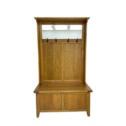 Oak mirror-back hall bench, projecting cornice, rectangular bevelled plate over four coat hooks, hinged box seat compartment with panelled front, on square tapering feet