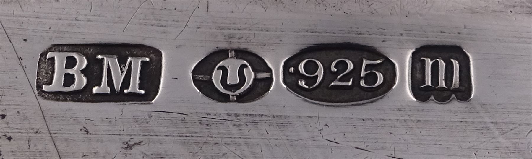 Late 19th century German Hanau silver box, of shaped rectangular form, embossed throughout, the hinged cover decorated with a central oval panel depicting a genre scene with musicians, the corners detailed with masks, the sides detailed with conforming figures and musical trophies, opening to reveal a gilt interior, with Hanau marks for Neresheimer & Sohne, and hallmarked B Muller & Son, London import 1907, approximate weight 3.32 ozt (103.4 grams)