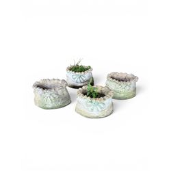 Four cast stone garden planters in the form of ribbon tied planting sacks