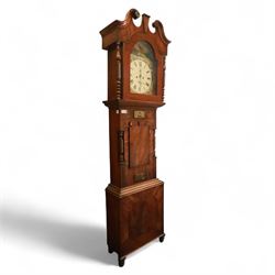 George Rutherford of Huddersfield- 8-day mahogany longcase clock c1880, with a swan neck pediment and turned patera, hood with shaped back splats and a break arch hood door flanked by ring turned pilasters, trunk with conforming recessed pilasters and a short wavy-topped trunk door, on a broad plinth raised on bracket feet, fully painted dial with matching pastoral depictions to the spandrels and break arch, with makers name, Roman numerals, subsidiary seconds and date dials and matching stamped brass hands, dial pinned via a falseplate to a rack striking movement striking the hours on a bell (bell missing). With pendulum, no weights.