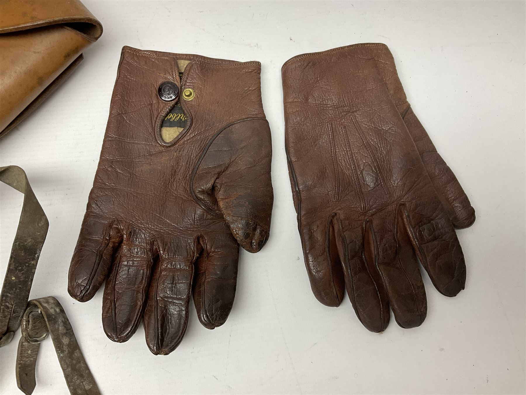 British Army General Staff officer's peaked cap by Herbert Johnson London in Moss Bros. delivery box; two officer's Sam Browne leather belts; leather pistol holster and sword hanger; pair of leather gloves and pair of spurs