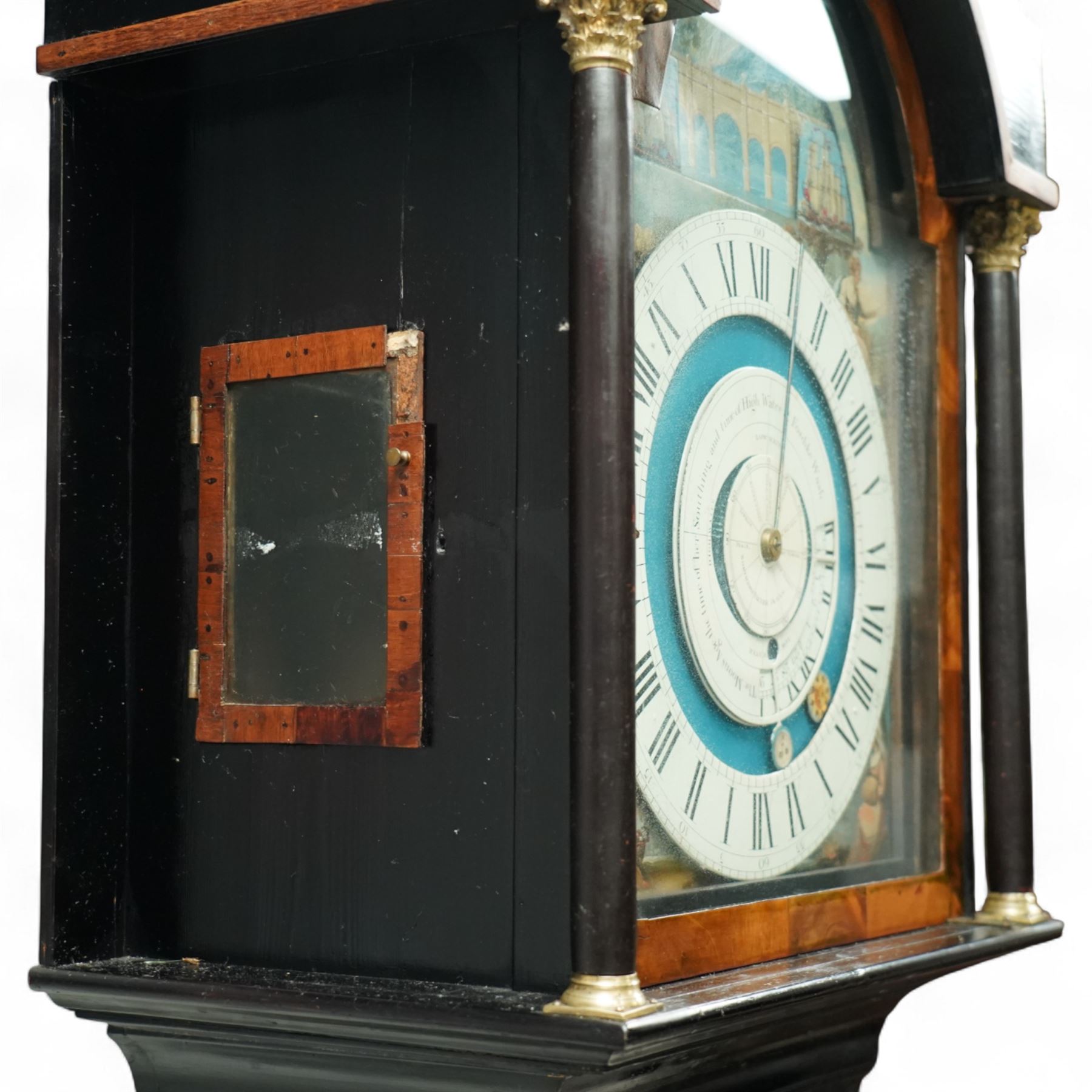 Thomas Emberson of Long Sutton (Lincolnshire) - Early 19th century longcase clock c1810 with a 30hr movement and an exceptionally rare 24-hour painted dial, housed in an ebonised Pine case with a flat pediment and break arch hood door, glazed side panels and turned pilasters with brass Corinthian capitals, trunk with a long door and conforming break arched top raised on a stepped plinth, fully painted dial with painted spandrels representing the four seasons and an operating automata depiction of ships at sea, rising and falling with the time of high and low water to the arch, with a 24-hour chapter with Roman numerals, five minute Arabic's, minute and inner quarter hour tracks, steel radial minute hand and image of the sun recording the hours, secondary inner dial illustrating the phases of the moon and lunar calendar recording the date and times of high and low water at Fosdike Wash (Lincolnshire), with an adjustable circular disc to the centre giving the times of high water at seven other locations including the Northern Pacific Ocean, dial attached to a countwheel striking chain driven movement, sounding the hours on a bell. With weight and pendulum.
Thomas Emberson is recorded not as a clockmaker but a machine maker from Long Sutton. This clock is also thought to have originally contained a musical movement, now removed, and was clearly an individual project possibly based on an earlier clock by John Ferguson illustrated in 
