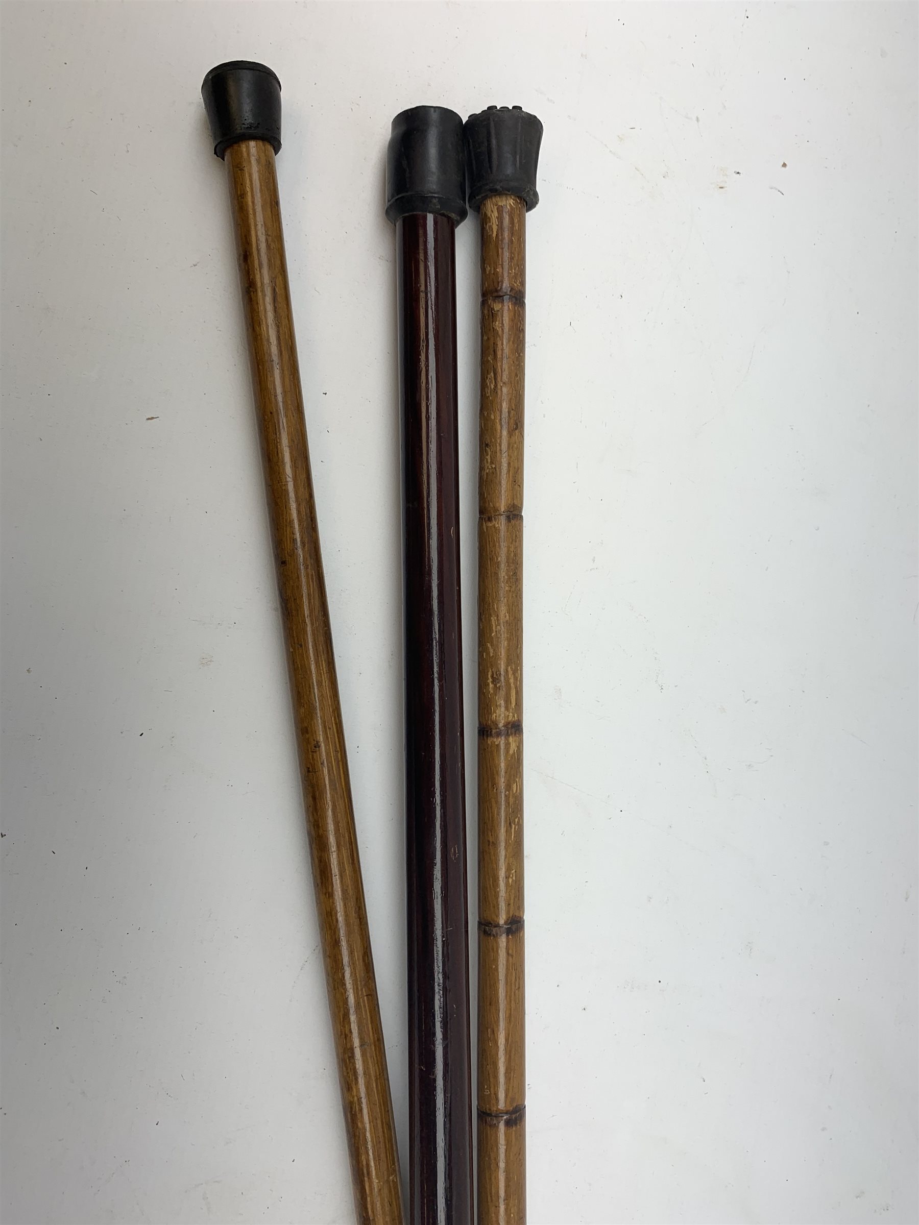 Three silver mounted walking canes, the first hallmarked Kendall & Sons Ltd, London, date letter worn and indistinct, the second hallmarked Birmingham 1924, maker's mark C&S, the third marked Sterling Silver, C&S. 