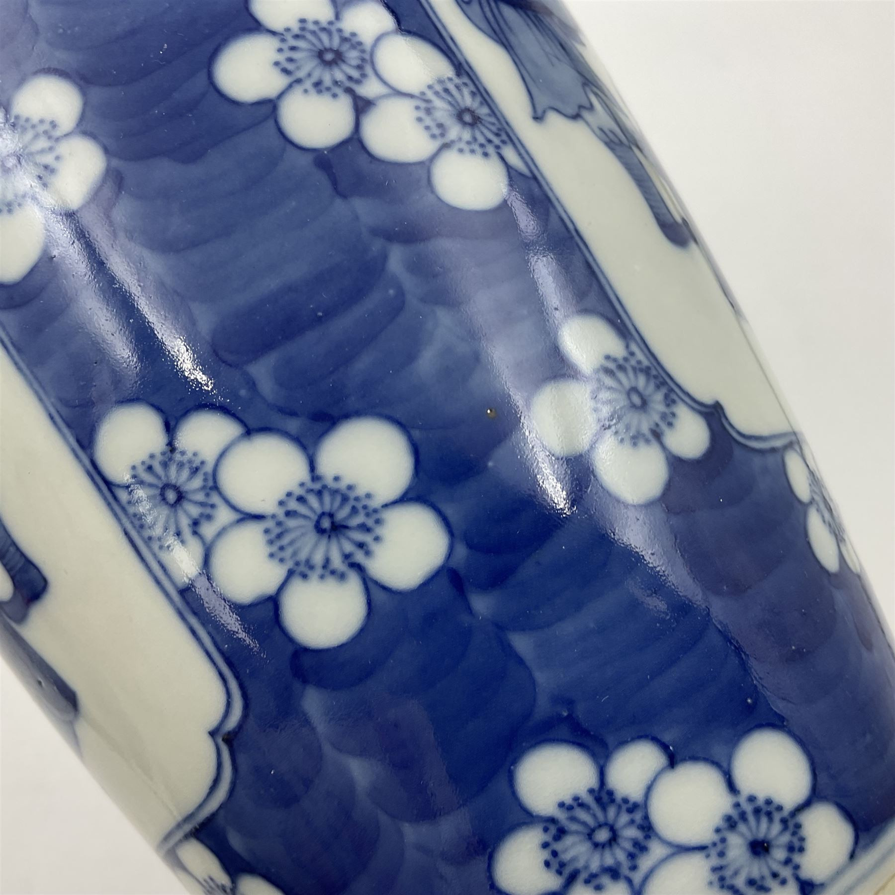 Late 19th century Chinese blue and white jar and cover, of slender ovoid form with domed cover, decorated with two reserves containing figures, against a prunus blossom ground, with Kangxi type mark beneath, H27.5cm