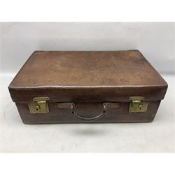 Late 19th/early 20th century brown leather suitcase, with two brass locks stamped B. Finnigan, Manchester, opening to reveal gilt tooled black compartmented interior, together with a Gladstone bag bearing initials H.A., suitcase W60cm D37cm H20cm