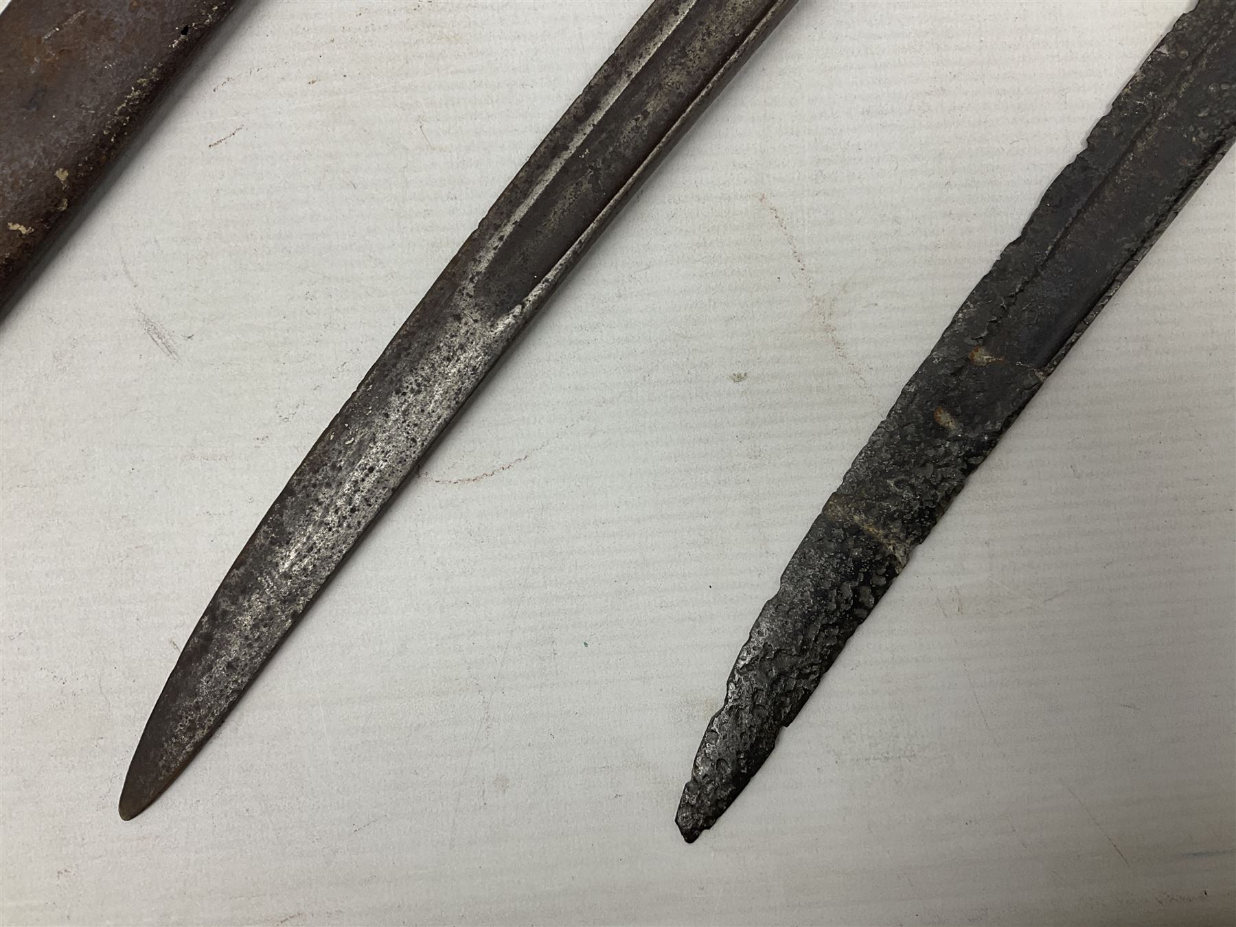 French Model 1874 Epee bayonet marked Oulle 1876 in associated scabbard; Model 1866 sabre bayonet in cut-down sword scabbard; and Model 1842/59 sabre bayonet in relic condition (3)