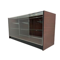 Shop display cabinet counter, glazed front and top, with mahogany laminate sides and back, enclosing two long adjustable shelves, fitted with two sliding cupboard doors to the rear, on castors
