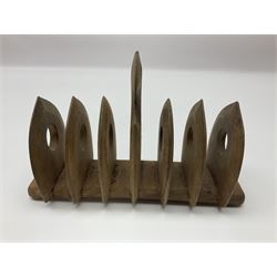 Pair of continental carved fruitwood figural bookends, H19cm, together with a carved wooden bulls head nut cracker and an Arts and Crafts style wooden seven bar toast rack