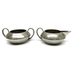Liberty & Co Tudric pewter three piece tea service, comprising teapot with woven reed handle, twin handled open sucrier, and milk jug, each of squat form with planished finish, each impressed beneath Tudric Pewter Ware 01537 Made in England