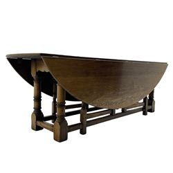 Large 18th century design oak wake or dining table, oval drop-leaf top, turned supports with double gate-leg action base, united by moulded stretchers 