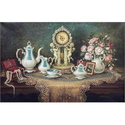 Anna Meszaros (Hungarian 1905-1998): Still Life of Tea Set and Mantle Clock on Table, oil on canvas signed 60cm x 90cm