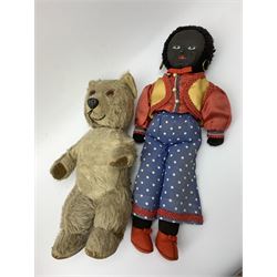 Mid-20th century teddy bear the plush covered body with applied eyes and nose and stitched mouth, fitted with manual wind musical movement which also turns the head H32cm; a golly with painted features, ear-rings and Romany style costume; and a quantity of books on dolls, teddy bears, toys and games