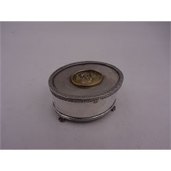 Modern silver limited edition music box, of oval form, with applied parcel gilt scene of sailing ships to centre of hinged cover, upon four claw feet, with musical mechanism within, no. 94/500, H4.3cm