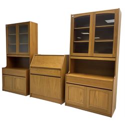Sutcliffe of Todmorden - pair of teak wall units, fitted with two glazed doors over drawer and double cupboard (W86cm, D45cm, H198cm); and a matching fall front bureau (W84cm, D41cm, H100cm)