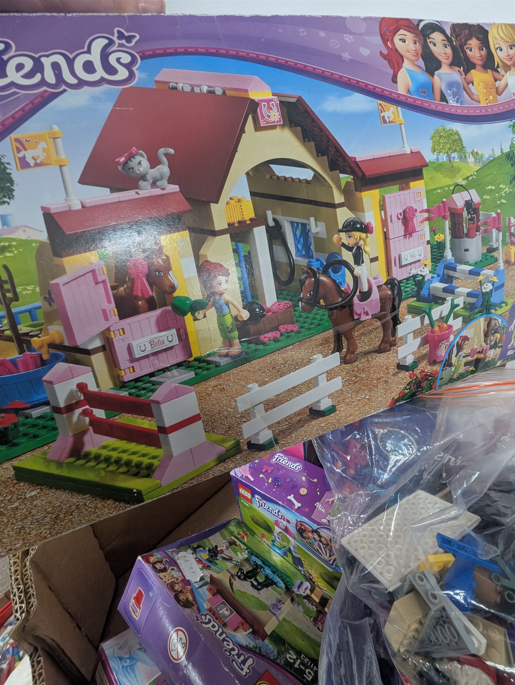 Lego Friends no. 3189 Stables set, Lego Trolls no. 41252 World Tour set, The Lego Movie set no. 70825, three small Lego Friends sets, all boxed and a quantity of loose Lego, including purple and pink colourways