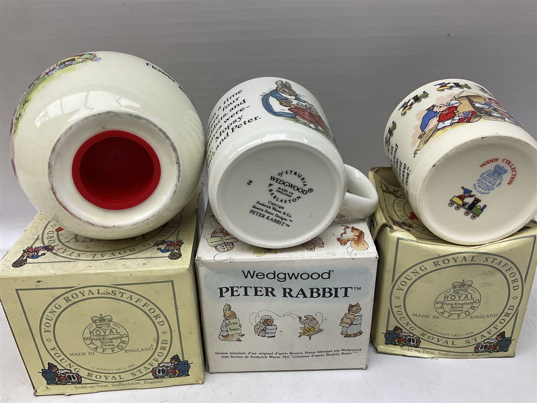 Royal Doulton Bunnykins nursery set in box and two cups, together with two Wedgwood Peter Rabbit mugs and Royal Staffordshire Noddy money box and cup (7)