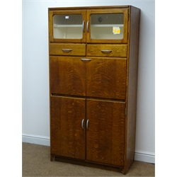  1950s oak kitchen cabinet, two glazed doors, two drawers above fall front and two cupboard doors, plinth base, W92cm, H175cm, D42cm  