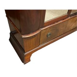 Late 19th century mahogany double wardrobe, projecting cornice over figured frieze, curved uprights enclosing two doors with bevelled mirrors, drawer to base, on splayed bracket feet