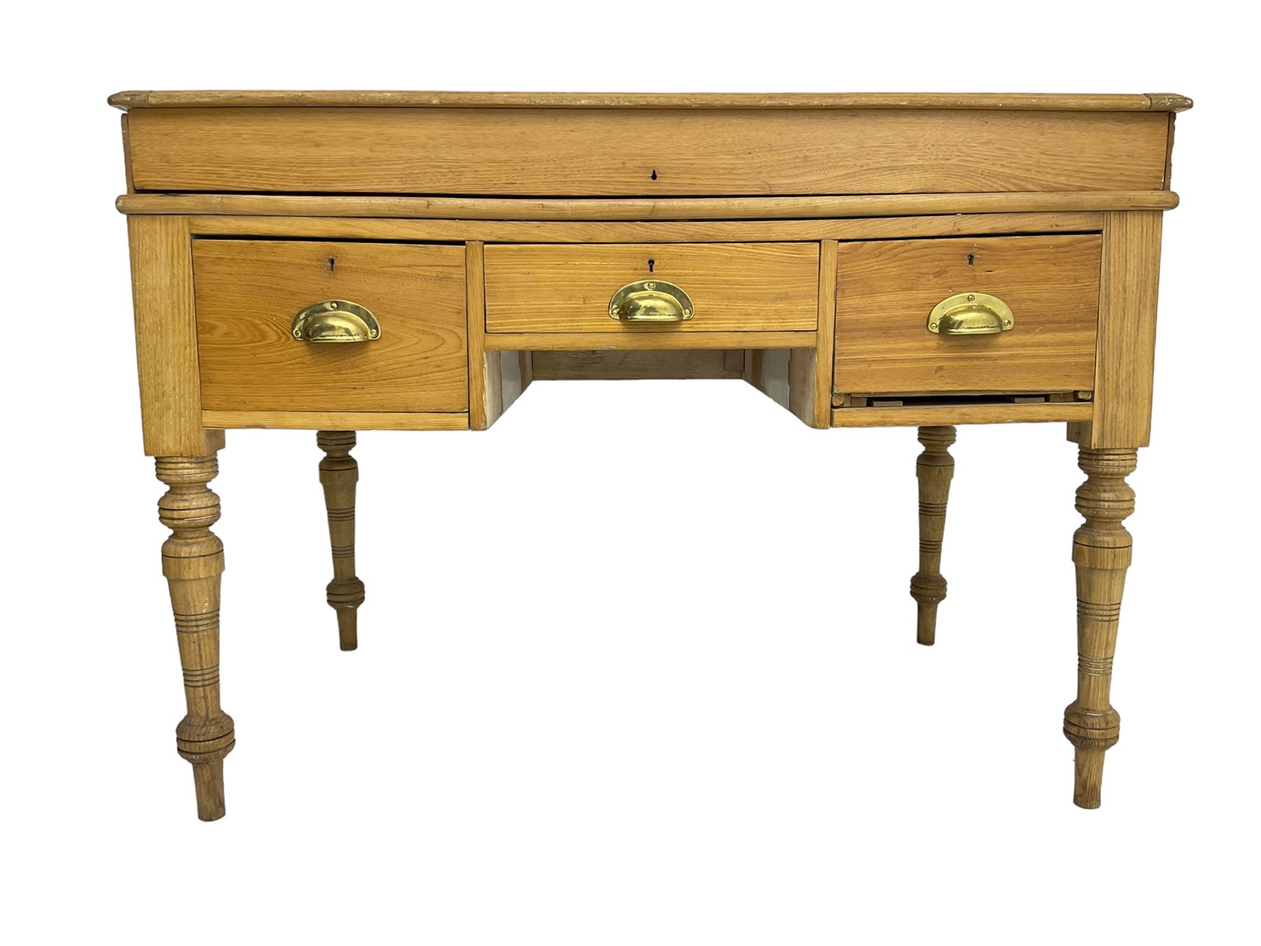 Early 20th century light oak kneehole desk, rectangular hinged top, fitted with frieze drawer flanked by two deep drawers, raised on ring turned supports