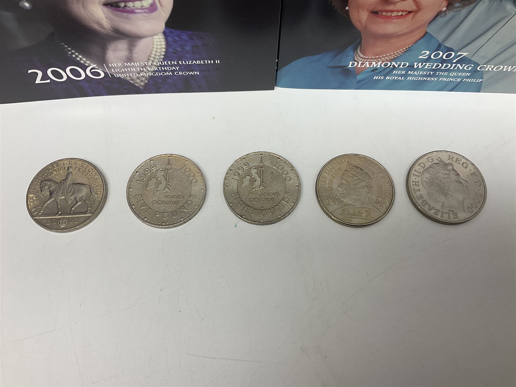 Seven Queen Elizabeth II United Kingdom five pound coins, including 2006 and 2007 in card folders, etc. 