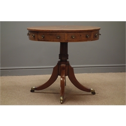  Early 19th century rosewood and inlaid drum table, eight segment veneered top, four false and four working drawers, turned column, splayed supports with brass cups and castors, D79cm, H74cm   