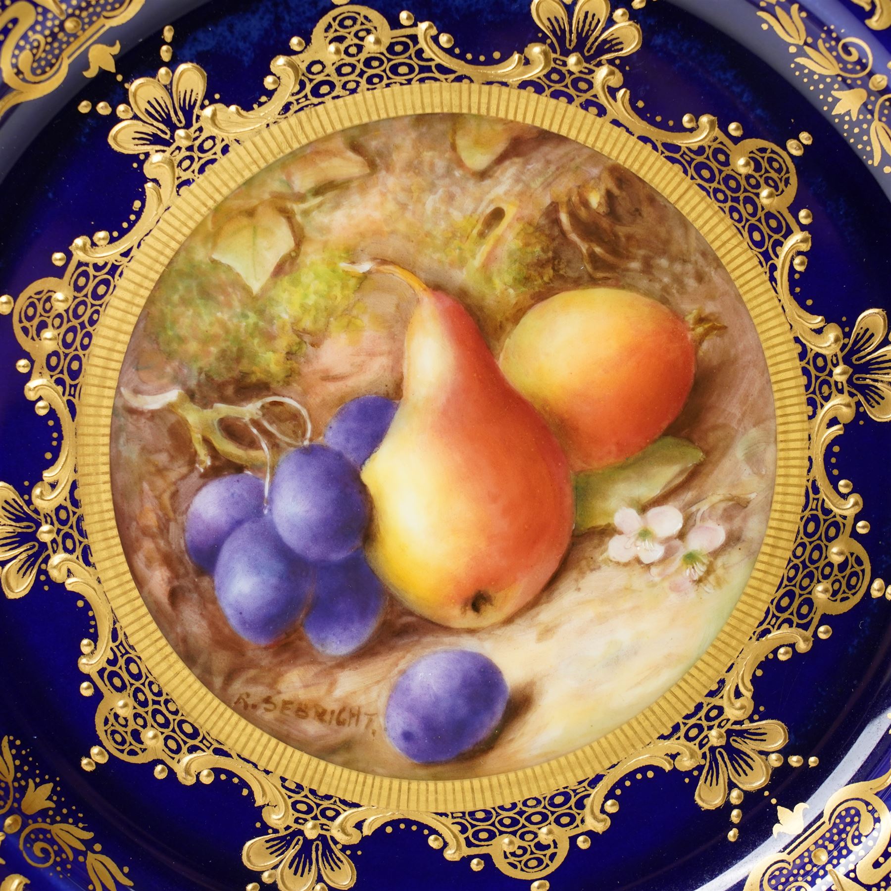 Royal Worcester Cabinet Plate, painted by Richard Sebright, the central panel decorated with fruit, within an elaborate gilt border on a cobalt ground, marked to base, D22cm 