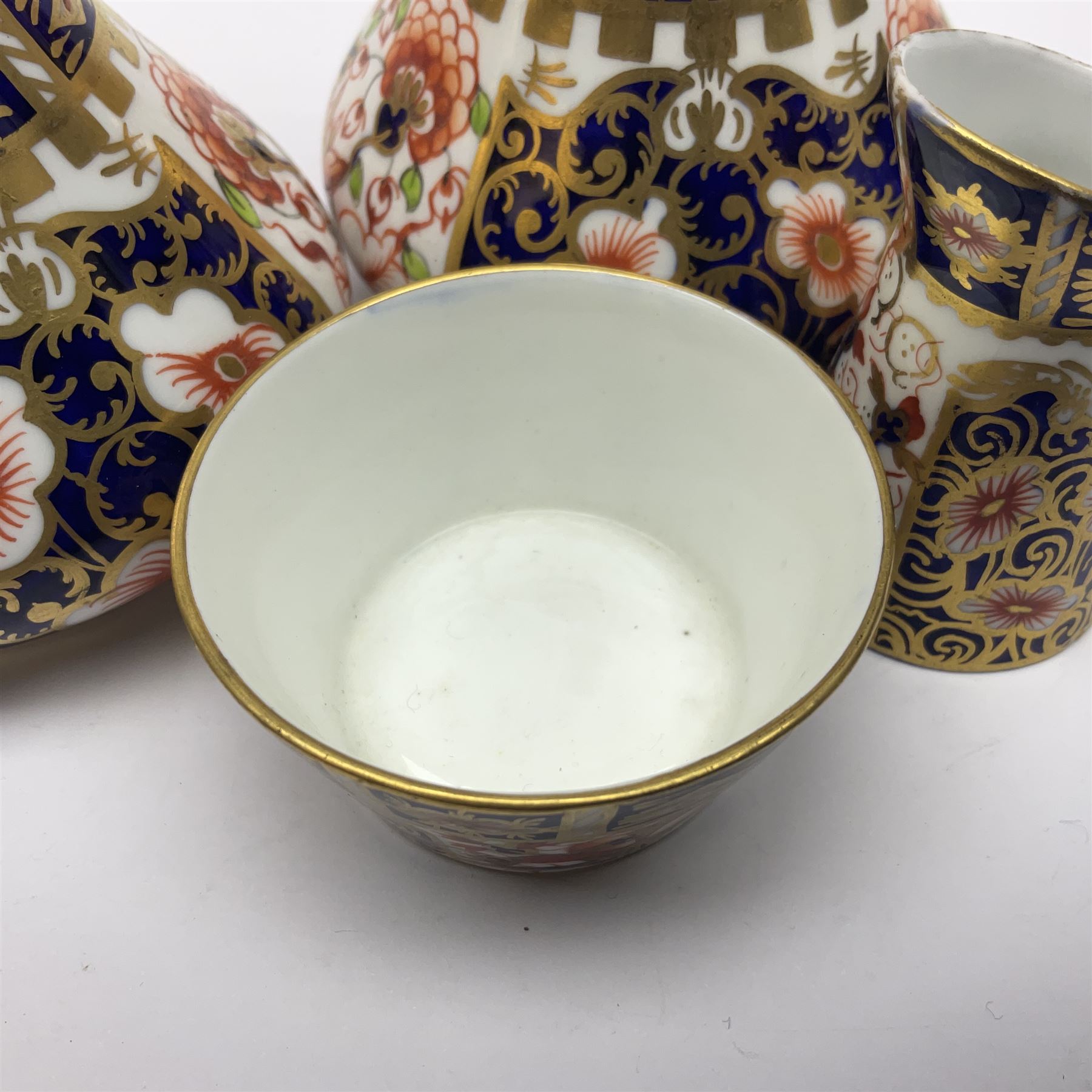 Pair of Royal Crown Derby 6299 imari pattern miniature vases, together with a miniature pitcher and dish in 2451 imari pattern, all with printed marks beneath, vase H12cm 