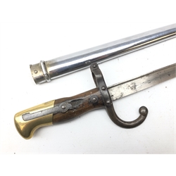  French Gras Bayonet, 52.5cm tapering steel triangular blade engraved St.Etienne 1899, guard stamped 80185 with curved quillon, wooden grip with brass pommel, in chromed scabbard, L66cm   