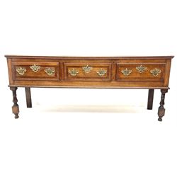 George III cross banded oak dresser, three drawers, shaped brass handles, baluster supports