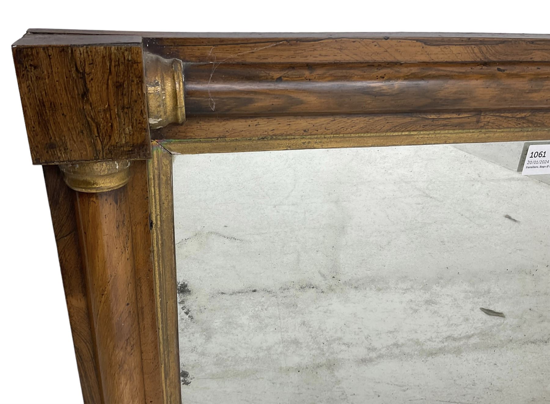 Early 19th century rosewood overmantel mirror, rectangular form with turned half pilasters, moulded gilt slip enclosing plain mirror plate, on turned feet